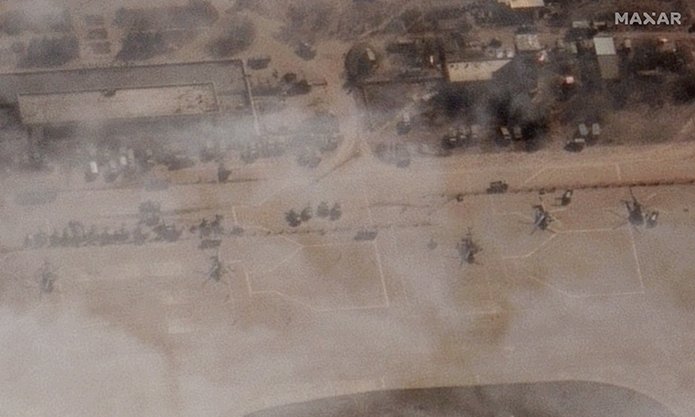 A satellite image from Maxar Technologies shows a number of Russian military helicopters sitting on the tarmac at the airport on Monday.