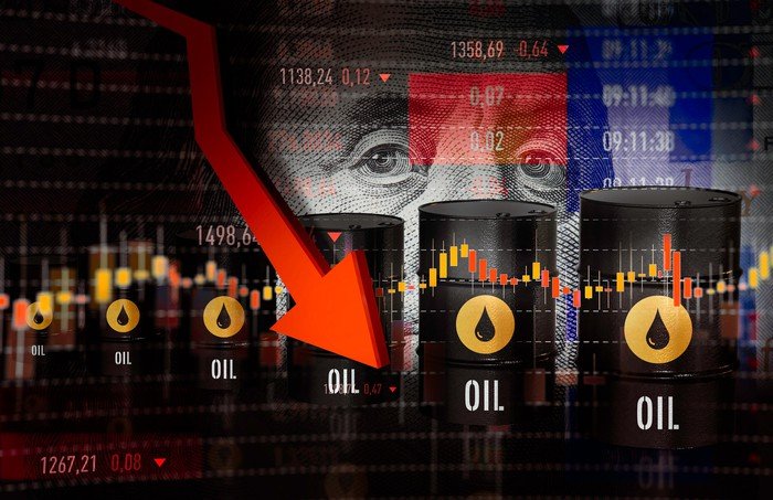 A pictorial graph with oil barrels showing declining oil prices. 